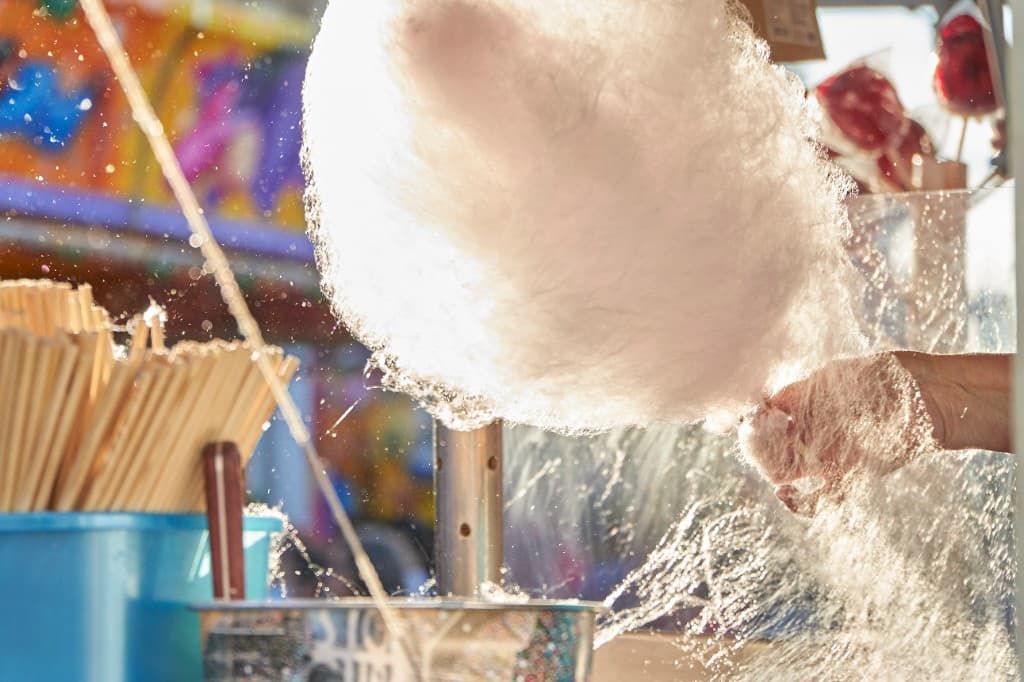 White cotton candy being spun onto a stick for a sugar floss rental add-on in South Florida.